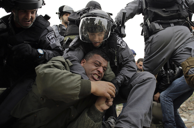 Israeli forces detain a Palestinian man at a protest in the occupied West Bank, near the town of Abu Dis on February 16, 2015 (Reuters/Ammar Awad)