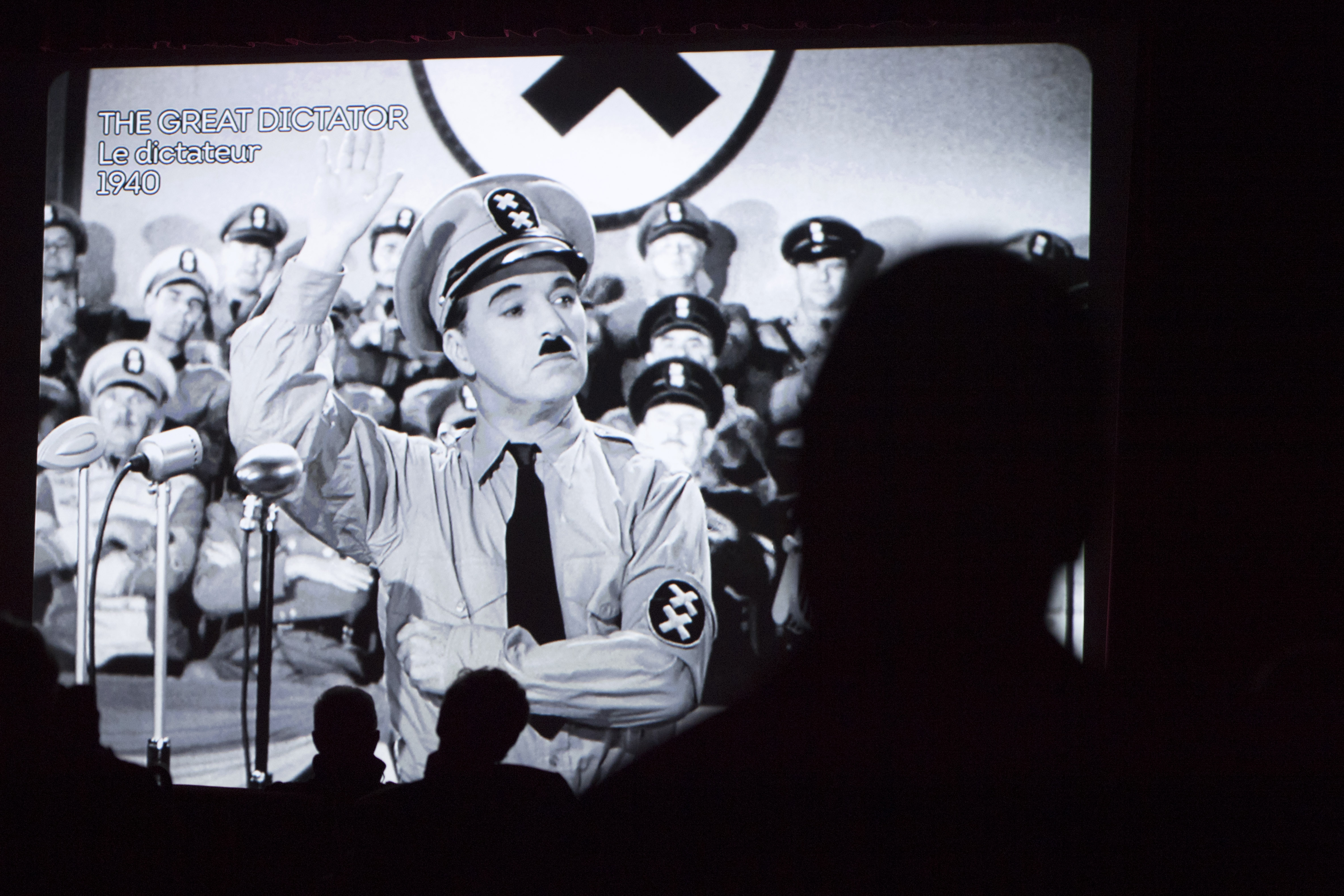 Spectators watch  the  movie  "The Great Dictator" with actor Charlie Chaplin  in the cinema   during the inauguration and the opening of the museum "Chaplin's World by Grevin" at the Manoir de Ban, in Corsier-Sur- Vevey, Switzerland, Saturday, April 16, 2016. (Laurent Gillieron/Keystone via AP)