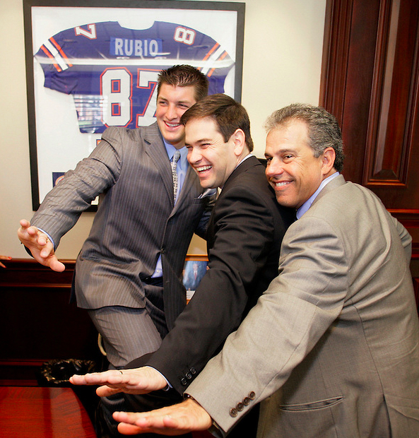 University of Florida quarterback and 2007 Heisman Trophy winner Tim Tebow (L), Speaker of the Florida House of Represenatives Marco Rubio, (C) and University of Florida board of trustee member Carlos Alfonso strike a Heisman pose in Rubio's office at the Florida State Capitol April 24, 2008. (Mark Wallheiser/TallahasseeStock.com)