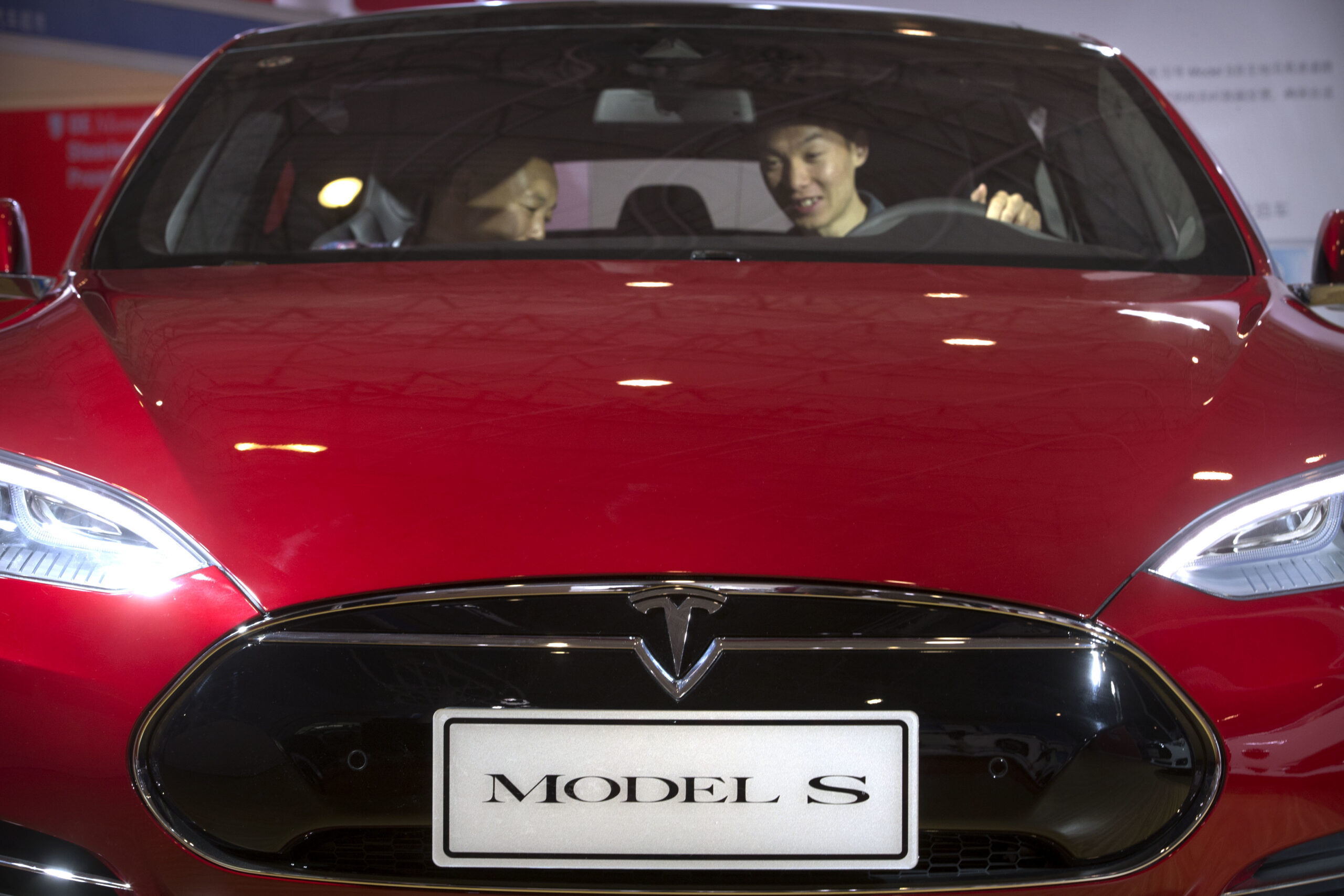 FILE - In this Monday, April 25, 2016, file photo, a man sits behind the steering wheel of a Tesla Model S electric car on display at the Beijing International Automotive Exhibition in Beijing. Tesla reports financial results Wednesday, May 4, 2016. (AP Photo/Mark Schiefelbein, File) (AP)