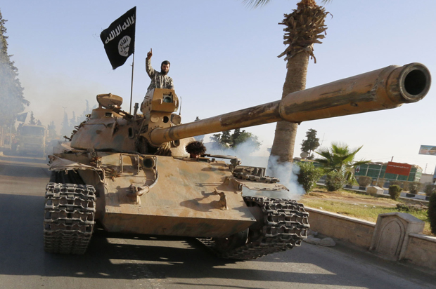 Militant Islamist fighters on a tank take part in a military parade along the streets of northern Raqqa province June 30, 2014. (Reuters)