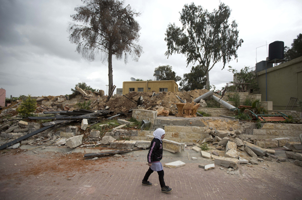 A Palestinian girl passes the ruins of a children's garden after it was demolished by Israeli troops in the village of Za'tara near the West Bank city of Nablus, April 12, 2016. (AP/Majdi Mohammed)