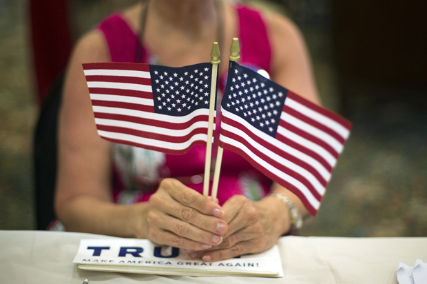 A volunteer hands out flags at a Donald Trump Rally in Bluffton, S.C., July 21, 2015. (AP/Stephen B. Morton)
