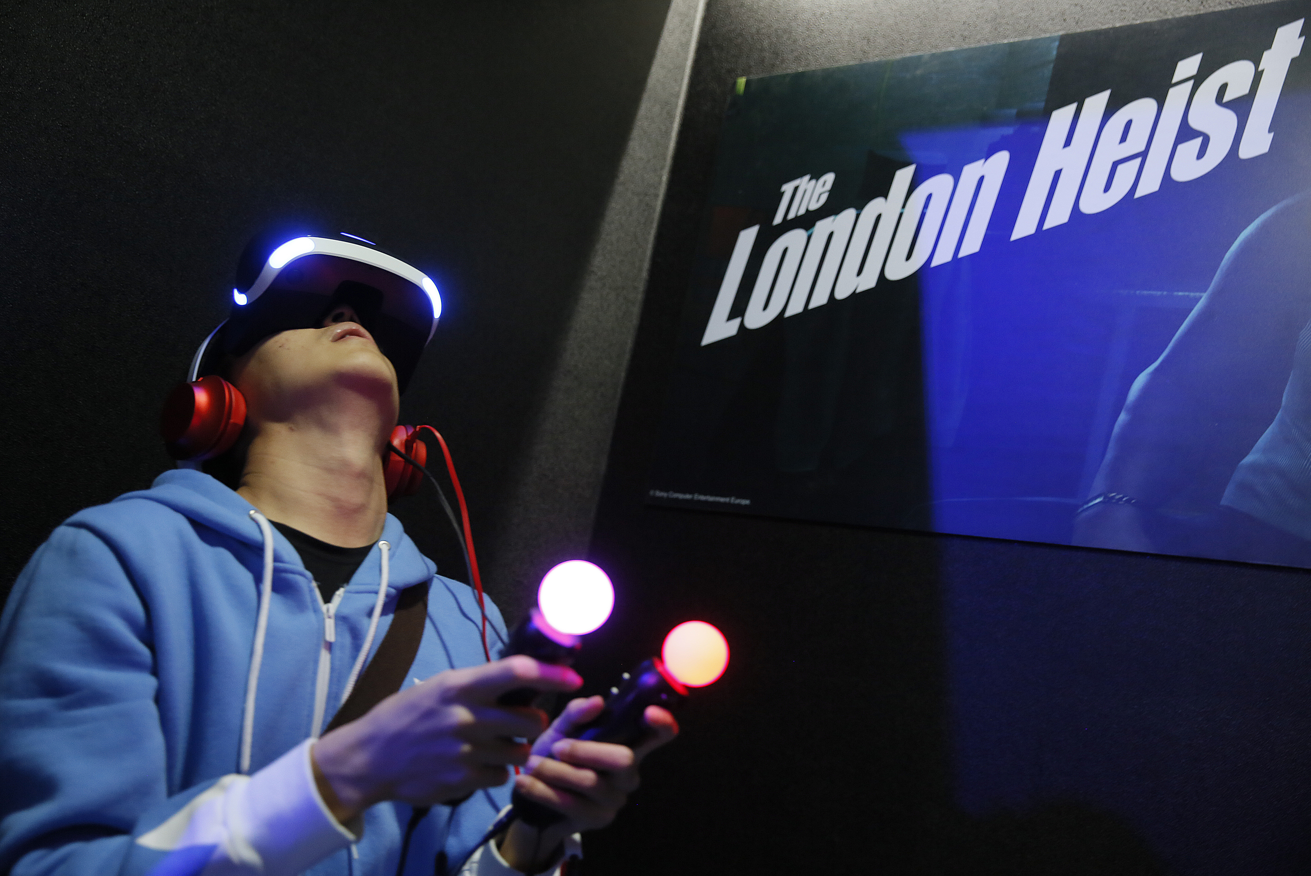 FILE - In this Jan. 29, 2016 file photo, a video game enthusiast experiences the Playstation VR virtual reality headset with the game "The London Heist" at the Taipei Game Show 2016 in Taipei, Taiwan. After delaying orders because of component shortages and angering wannabe early adopters, VR company Oculus is confronting another headache as it seeks to technologically and culturally establish the immersive medium. It's now possible to play titles that were intended to only be used with the Oculus Rift system on an entirely different VR headset. (AP Photo/Wally Santana, File) (AP)