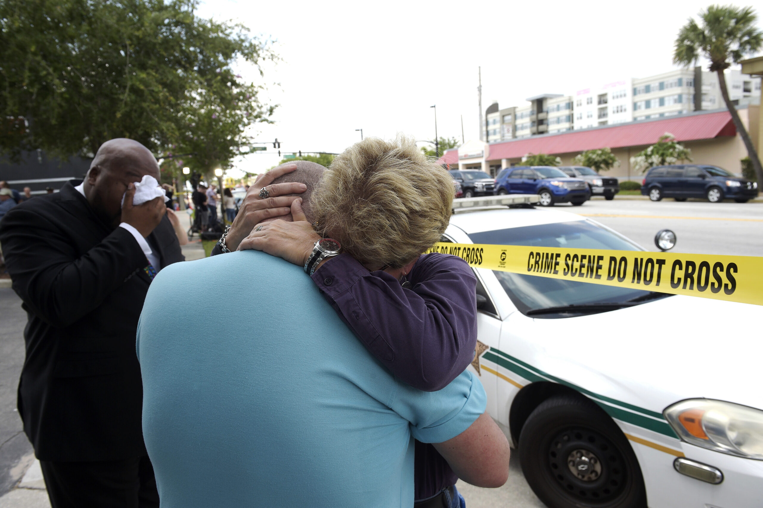 Terry DeCarlo, executive director of the LGBT Center of Central Florida, center, is comforted by Orlando City Commissioner Patty Sheehan. (AP/Phelan M. Ebenhack)