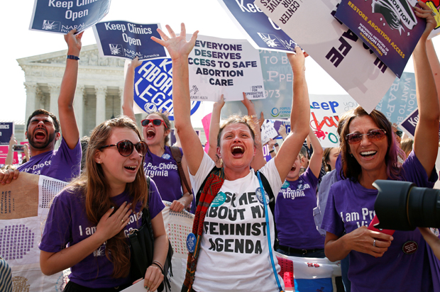 Demonstrators celebrate at the U.S. Supreme Court after it struck down a Texas law imposing strict regulations on abortion doctors and facilities, June 27, 2016. (Reuters/Kevin Lamarque)