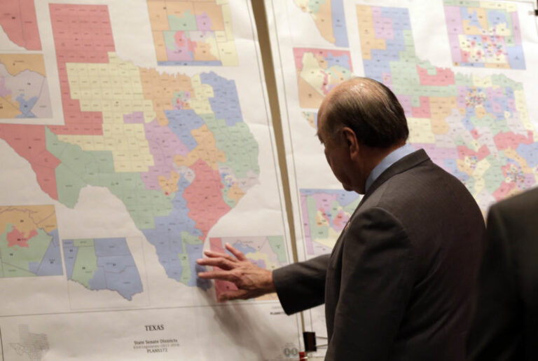 FILE - In this May 30, 2013 file photo, Texas state Sen. Juan "Chuy" Hinojosa looks at maps on display prior to a Senate Redistricting committee hearing in Austin, Texas.(AP Photo/Eric Gay, File) (AP/Eric Gay)