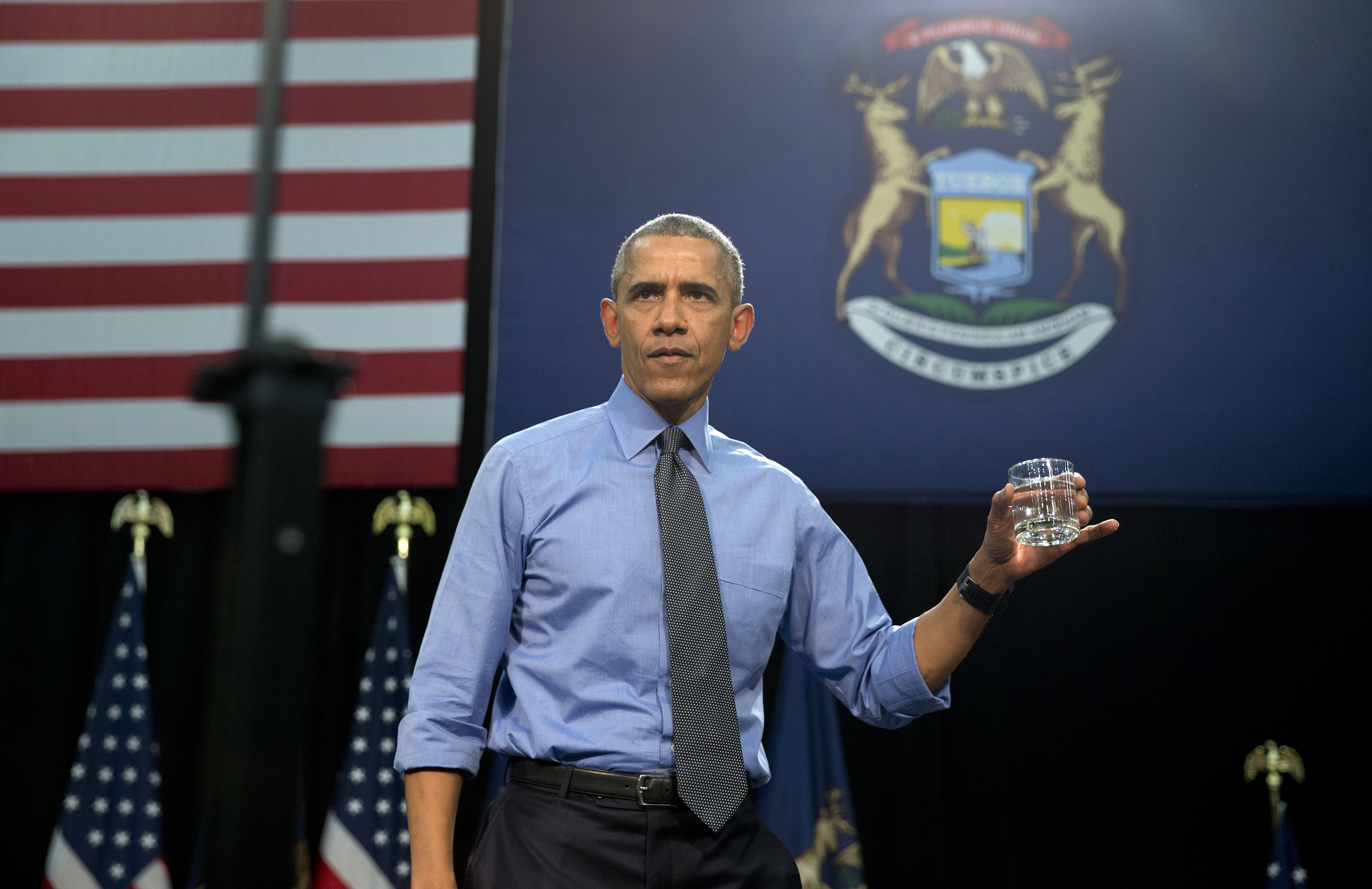 FILE - In this May 4, 2016 file photo, President Barack Obama holds up a glass of water he will drink from, after speaking at Flint Northwestern High School about the ongoing water crisis, in Flint, Mich. Flints lead-contaminated water crisis has affected all of the citys nearly 100,000 residents, but some grapple with an extra challenge: A language barrier. Obama, who declared a state of emergency in the city in mid-January and ordered federal aid to supplement the state and local response, visited Flint in May. (AP Photo/Carolyn Kaster, File) (AP)
