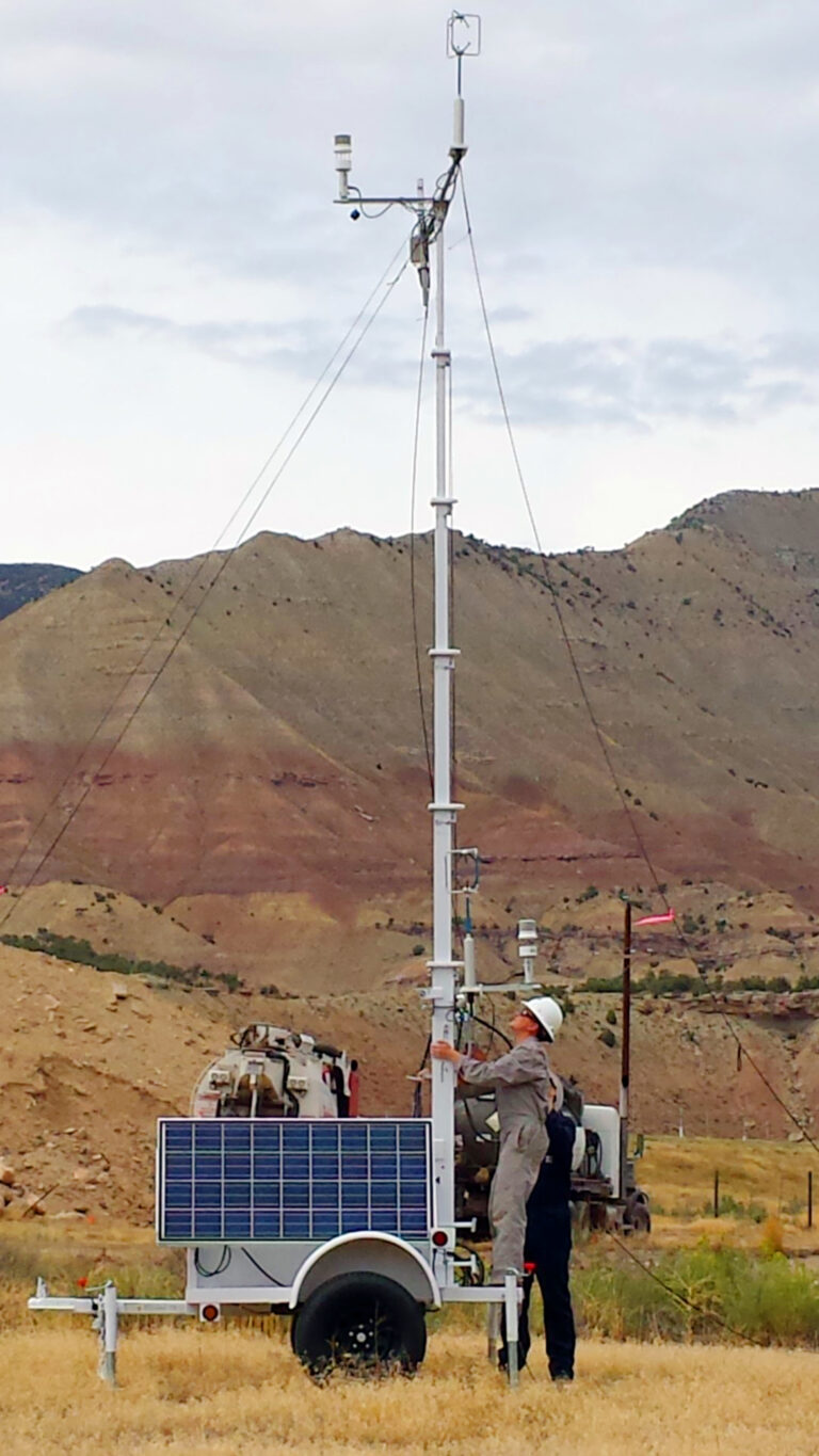 In this 2014 photo provided by Colorado State University, CSU research associate Kira Shonkwiler, front, and student Landan MacDonald, standing behind Shonkwiler, set up a weather station in Garfield County, Colo., as part of a study on air pollution from fracking wells. (AP)