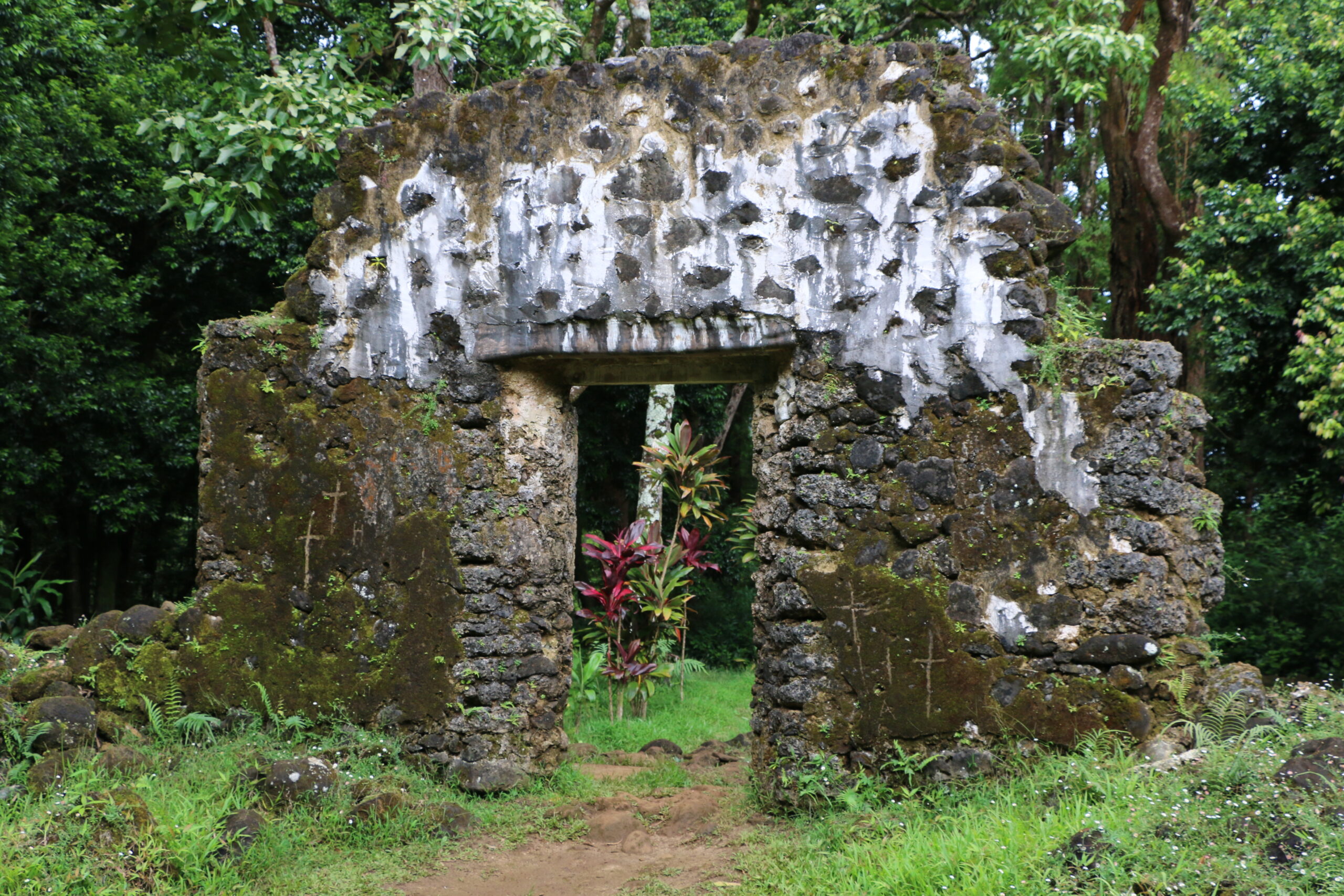 This undated photo, provided by the Hawaii Department of Land and Natural Resources, shows the crumbling remains of the 180-year-old summer palace of former King Kamehameha III where vandals etched crosses in the forest of a Honolulu, Hawaii, neighborhood. The Department said Thursday, June 23, 2016, that unless the vandals are caught desecrating the sacred cultural site, there's little law enforcement officers can do.(Hawaii Department of Land and Natural Resources via AP) (Hawaii Department of Land and Natural Resources via AP)