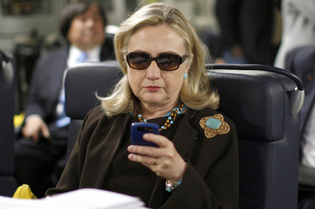 U.S. Secretary of State Hillary Clinton checks her phone in October 18, 2011 (REUTERS/Kevin Lamarque)