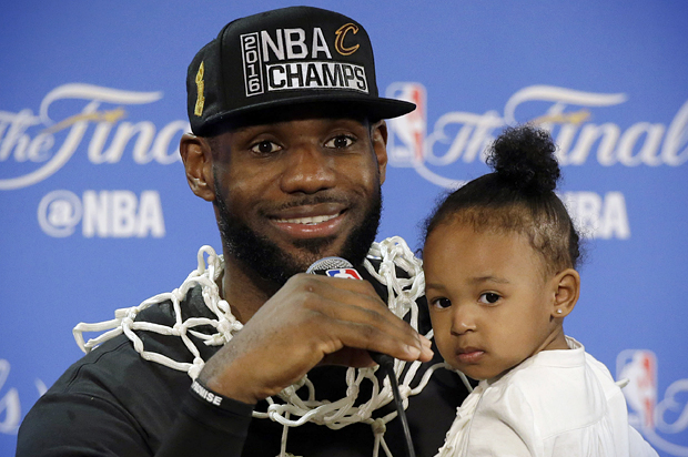 LeBron James answers questions as he holds his daughter Zhuri during a post-game press conference, June 19, 2016, in Oakland. (AP/Eric Risberg)