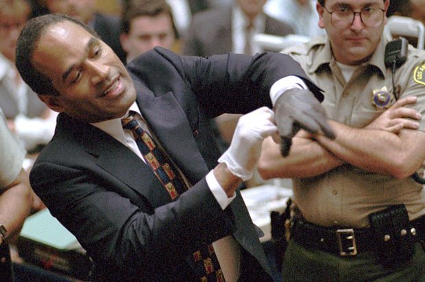 Murder defendant O.J. Simpson tries on glove, June 15, 1995 (Sam Mircovich/AP)
