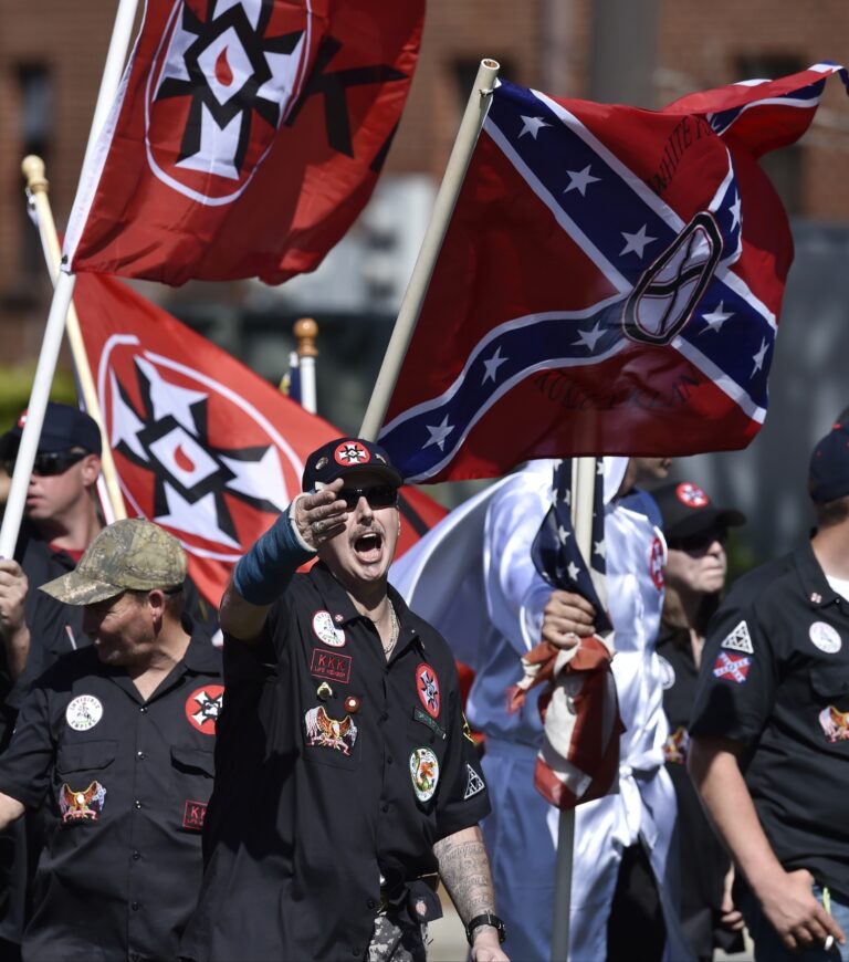 In this Saturday, April 23, 2016 photo, Loyal White Knights Grand Dragon Will Quigg of Anaheim, Calif., center, shouts to protestors during a "White Pride," rally, in Rome, Ga. (AP)
