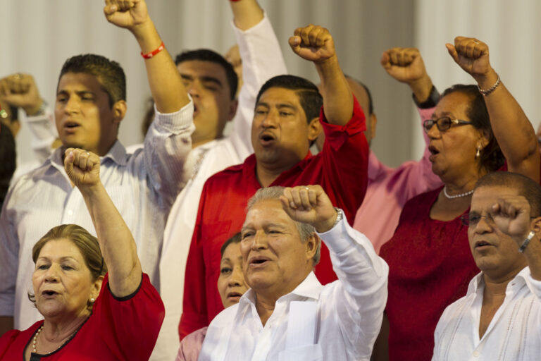 FILE - In this June 1, 2014 file photo, El Salvador's President Salvador Sanchez Ceren sings the Farabundo Marti National Liberation Front anthem during a rally with party supporters after his swearing-in ceremony in San Salvador, El Salvador. Sanchez Ceren says he has begun talks with political parties on a new "national reconciliation" law after the Supreme Court overturned an amnesty covering crimes committed during the 1980-1992 civil war. (AP Photo/Moises Castillo, File) (AP)