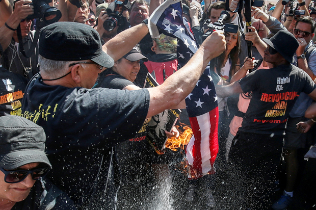 Protesters burn the U.S. flag outside the Republican National Convention in Cleveland, July 20, 2016. (Reuters/Adrees Latif)