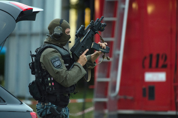 Police near the shopping center where a mass shooting took place in Munich, Germany on Friday, July 22, 2016 (AP/Matthias Balk)