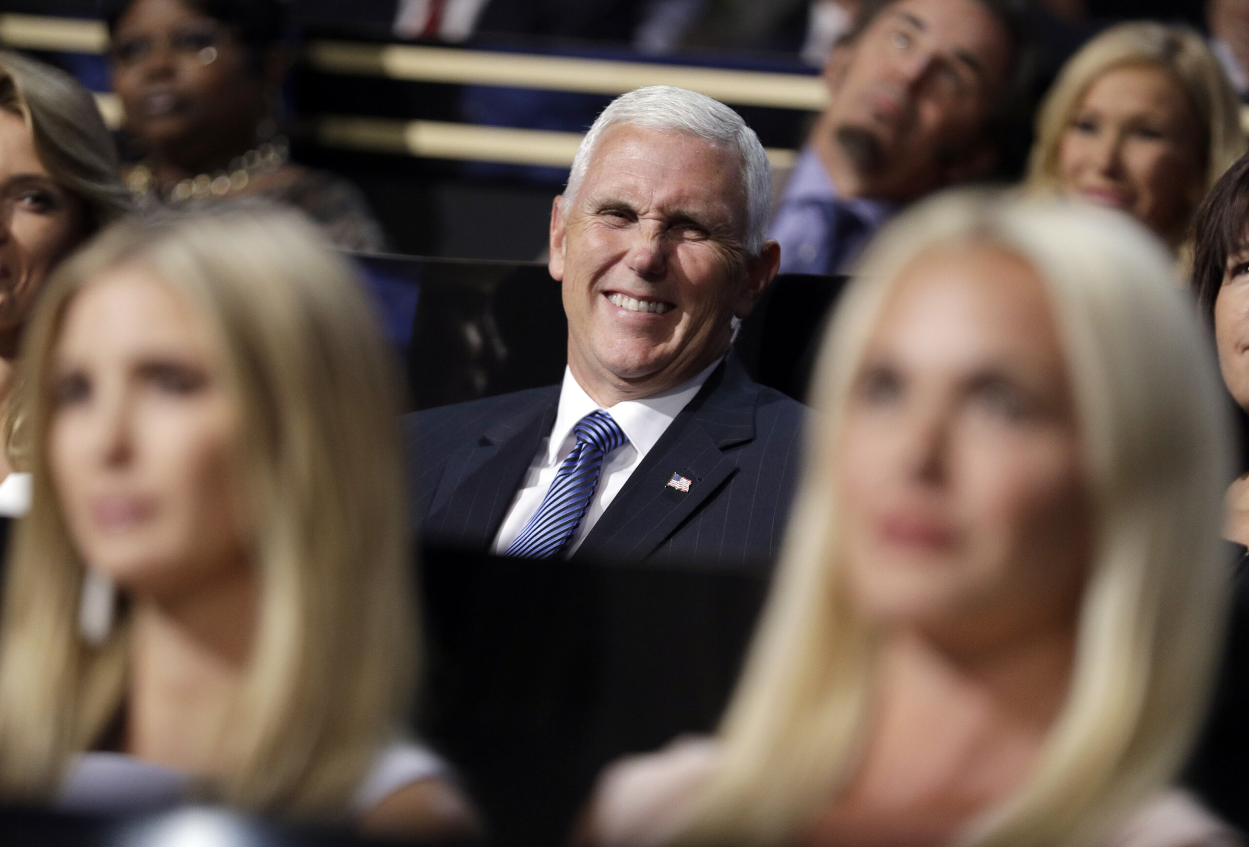 Vice Presidential nominee Gov. Mike Pence of Indiana smiles as he sits during the second day session of the Republican National Convention in Cleveland, (AP)