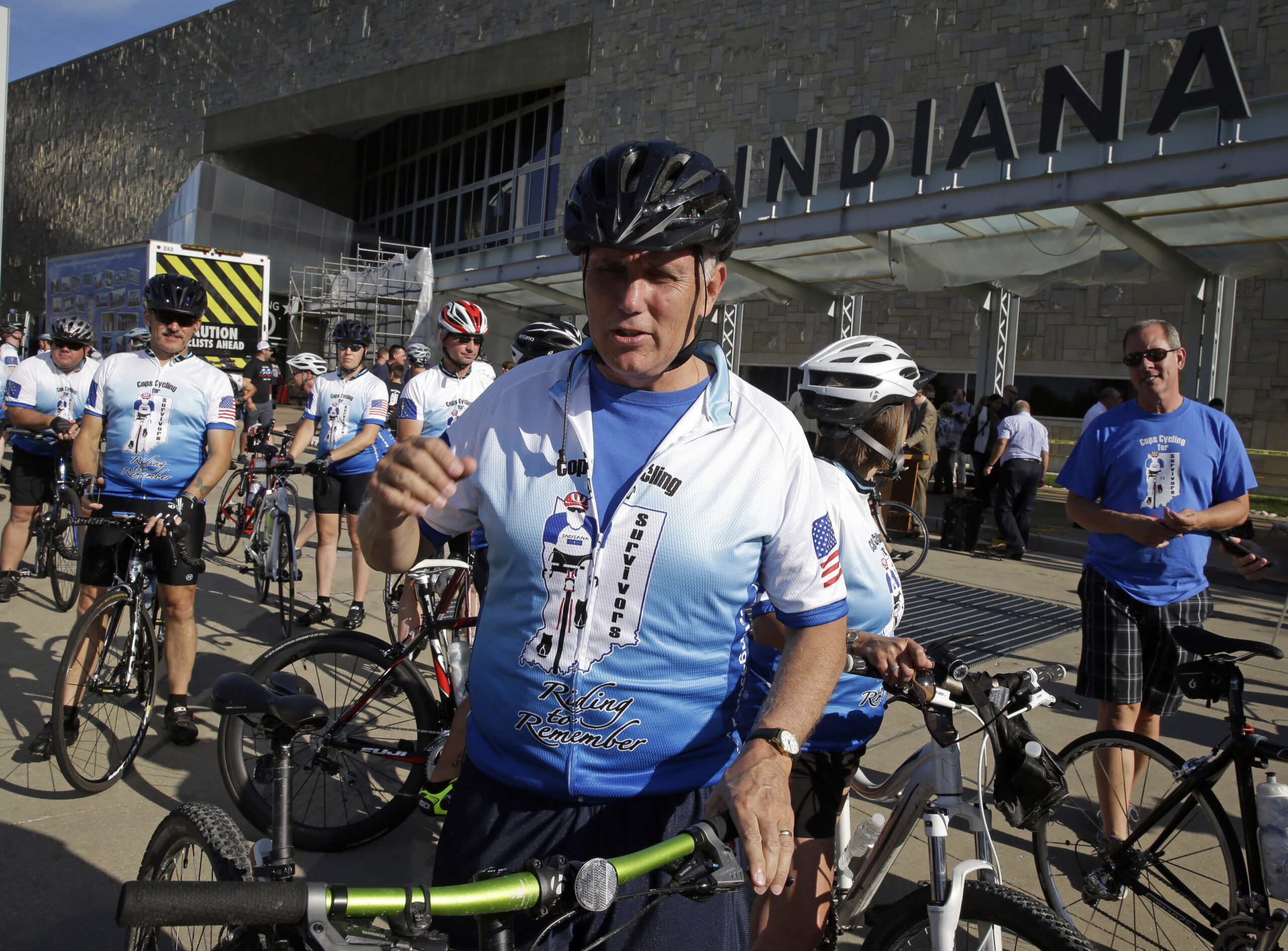 Indiana Gov. Mike Pence prepares to ride the opening segment of the Cops Cycling for Survivors fundraising bike ride in Indianapolis, Monday, July 11, 2016. (AP Photo/Michael Conroy) (AP Photo/Michael Conroy)