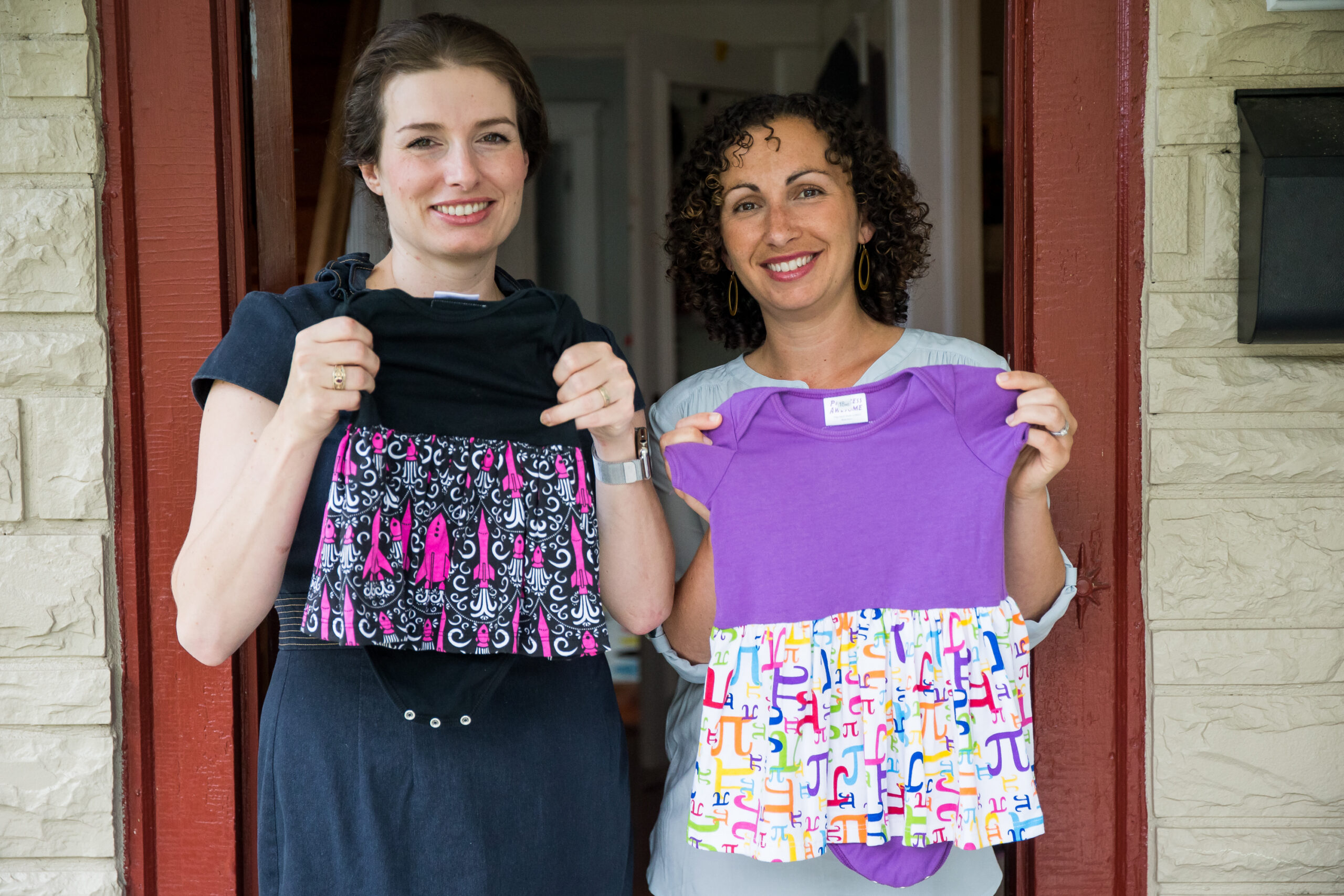 In this Tuesday, July 19, 2016, photo, Eva St. Clair, left, and Rebecca Melsky pose for a portrait at Melsky's home in Washington. Melsky and St. Clair design dresses for Princess Awesome, a girls' clothing line that uses traditional boys' motifs such as trains, dinosaurs, ninjas, and planes. (AP Photo/Zach Gibson) (AP)