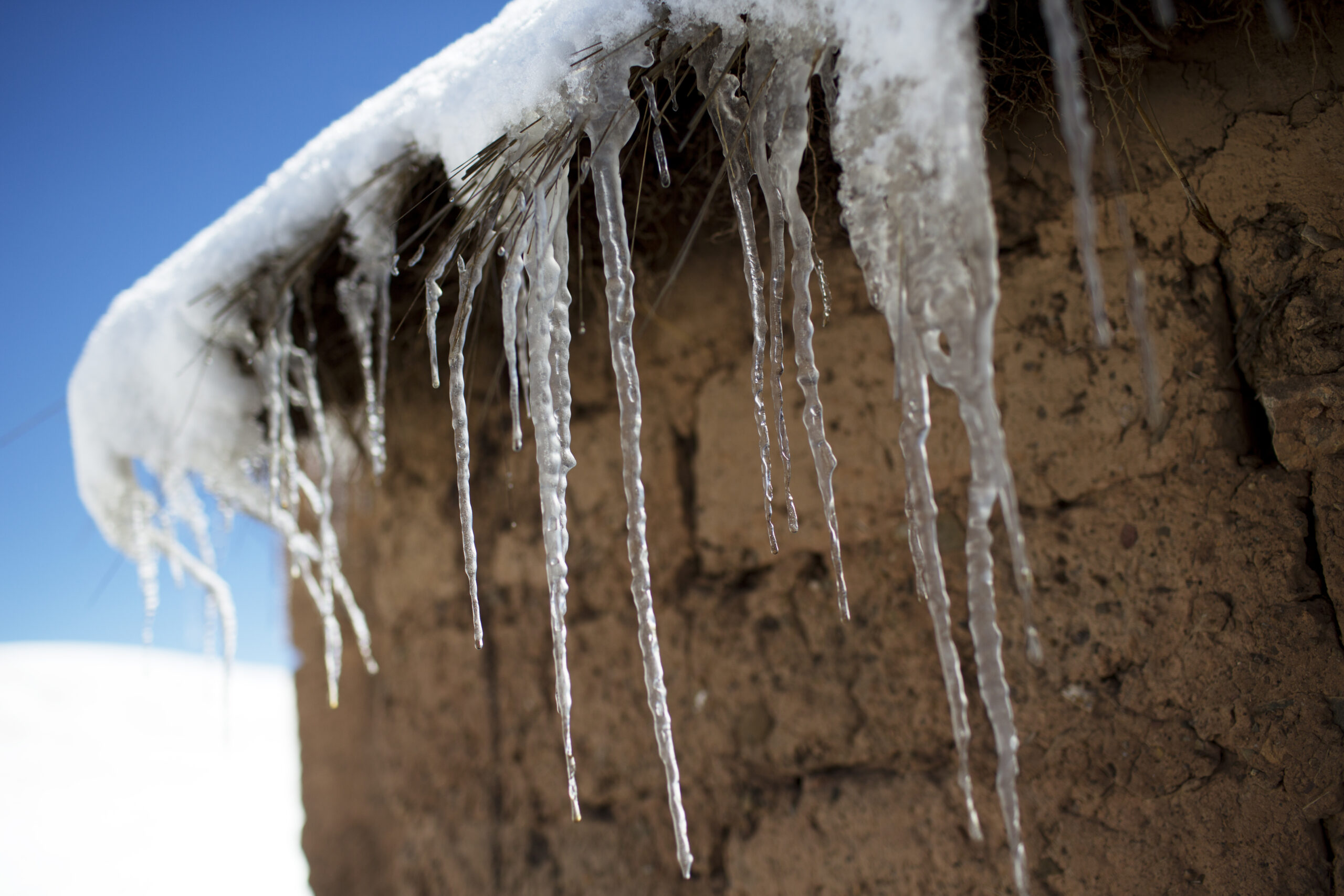 In this July 8, 2016 photo, icicles hang from the roof of an adobe home in San Antonio de Putina in the Puno region of Peru, where farmers raise alpacas and sheep for their wool. Every winter freeze destroys the tough grasslands the animals feed on and almost no crops can survive in the nutrient-poor soil. (AP Photo/Rodrigo Abd) (AP)
