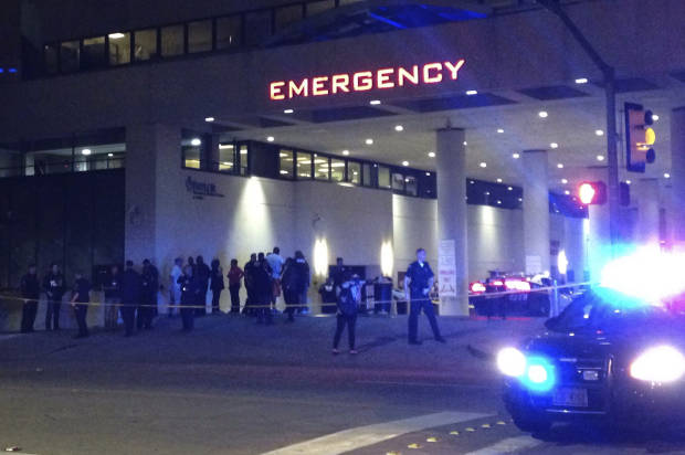 Police and others gather at the emergency entrance to Baylor Medical Center in Dallas, where several police officers were taken after shootings Thursday, July 7, 2016 (AP/Emily Schmall)