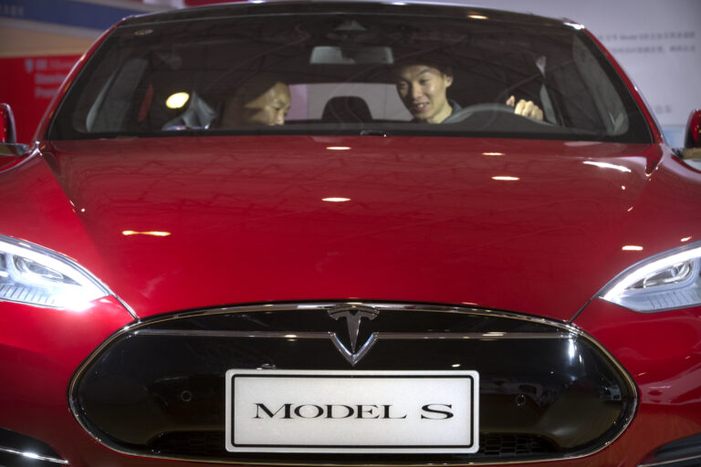 FILE - In this Monday, April 25, 2016, file photo, a man sits behind the steering wheel of a Tesla Model S electric car on display at the Beijing International Automotive Exhibition in Beijing. Federal officials say the driver of a Tesla S sports car using the vehicle’s “autopilot” automated driving system has been killed in a collision with a truck, the first U.S. self-driving car fatality. The National Highway Traffic Safety Administration said preliminary reports indicate the crash occurred when a tractor-trailer made a left turn in front of the Tesla at a highway intersection. NHTSA said the Tesla driver died due to injuries sustained in the crash, which took place on May 7 in Williston, Fla. (AP Photo/Mark Schiefelbein, File) (AP)