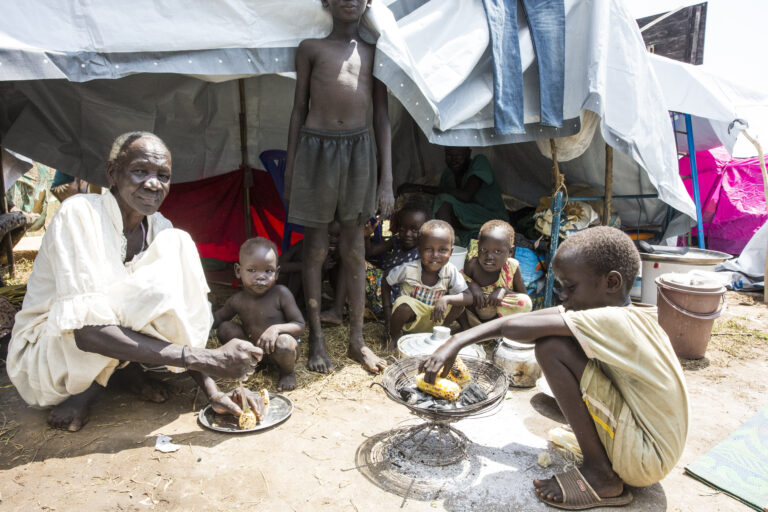 In this photo released by the United Nations Mission in South Sudan (UNMISS), children wait to be served with roasted maize in a refugee camp Juba, South Sudan Friday July 22, 2016  . The United Nations refugee agency says thousands of people continue to flee South Sudan over violence between armed groups in the country, stretching the capacity of humanitarian efforts to look after the refugees. 
 () (Isaac Billy UNMISS via AP)