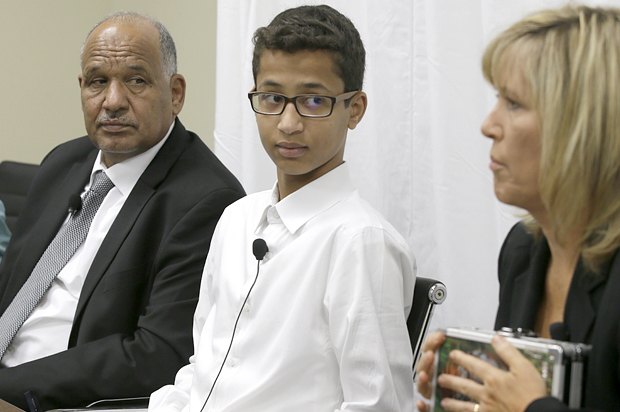 Ahmed Mohamed and father Mohamed Elhassan Mohamed look on as their lawyer Susan E. Hutchison speaks at a news conference in Dallas, Aug. 8, 2016. (AP/LM Otero)