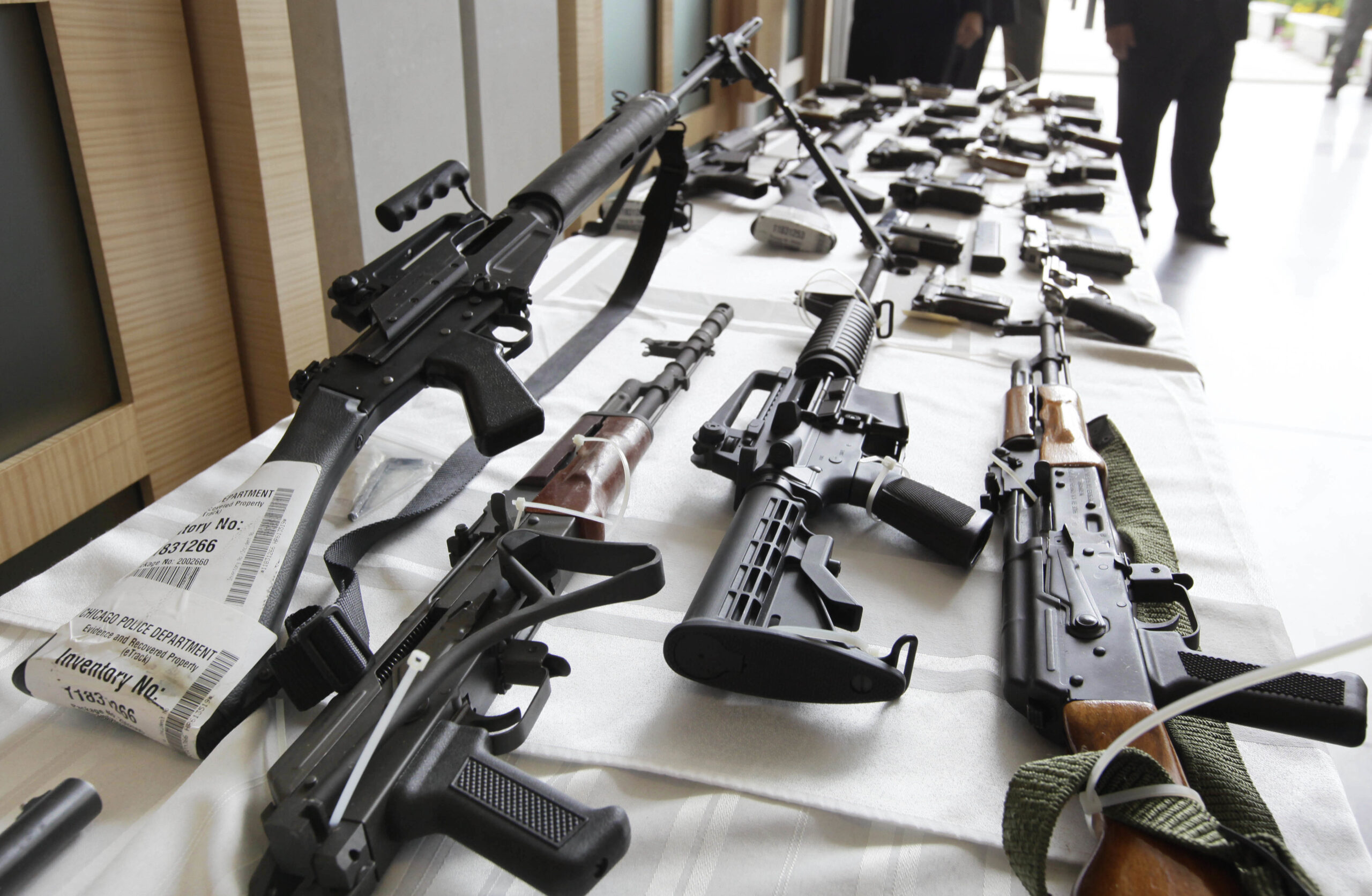 FILE - In this July 22, 2010, file photo, various guns are displayed at the Chicago FBI office. A new poll shows most young adults across racial and ethnic groups support tighter gun polices including background checks, stricter penalties for gun law violations, and banning semi-automatic weapons. In the new GenForward poll, about 9 in 10 young adults say they support criminal background checks for all gun sales, a level of support that remains consistent across racial and ethnic groups.(AP Photo/M. Spencer Green, File) (AP)