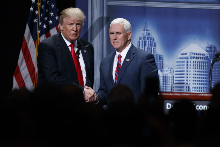 FILE- In this Aug. 8, 2016, file photo, Republican presidential candidate Donald Trump shakes hands with his running mate, Republican vice presidential candidate, Indiana Gov. Mike Pence as he arrives to give an economic policy speech to the Detroit Economic Club in Detroit. A campaign official familiar with the plans said Thursday, Aug. 18, that the GOP nominee and his running mate will tour the flood damage in ravaged Louisiana on Friday. (AP Photo/Evan Vucci, File) (AP)