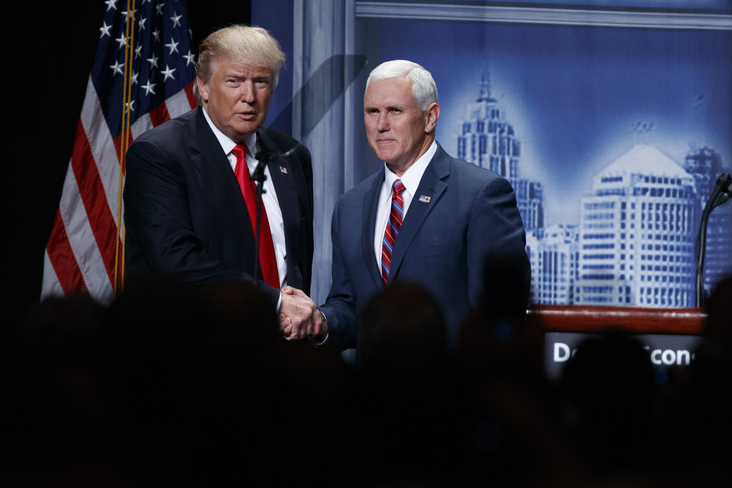 FILE- In this Aug. 8, 2016, file photo, Republican presidential candidate Donald Trump shakes hands with his running mate, Republican vice presidential candidate, Indiana Gov. Mike Pence as he arrives to give an economic policy speech to the Detroit Economic Club in Detroit. A campaign official familiar with the plans said Thursday, Aug. 18, that the GOP nominee and his running mate will tour the flood damage in ravaged Louisiana on Friday. (AP Photo/Evan Vucci, File) (AP)