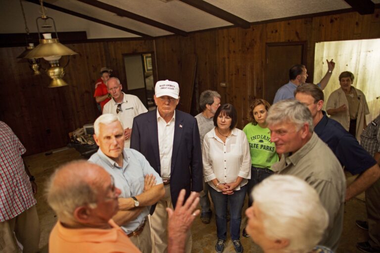 Republican presidential candidate Donald Trump, center, and his running mate, Indiana Gov. Mike Pence, listens to flood victims Jimmy and Olive Gordan during a tour of their flood damaged home in Denham Springs, La., (AP)