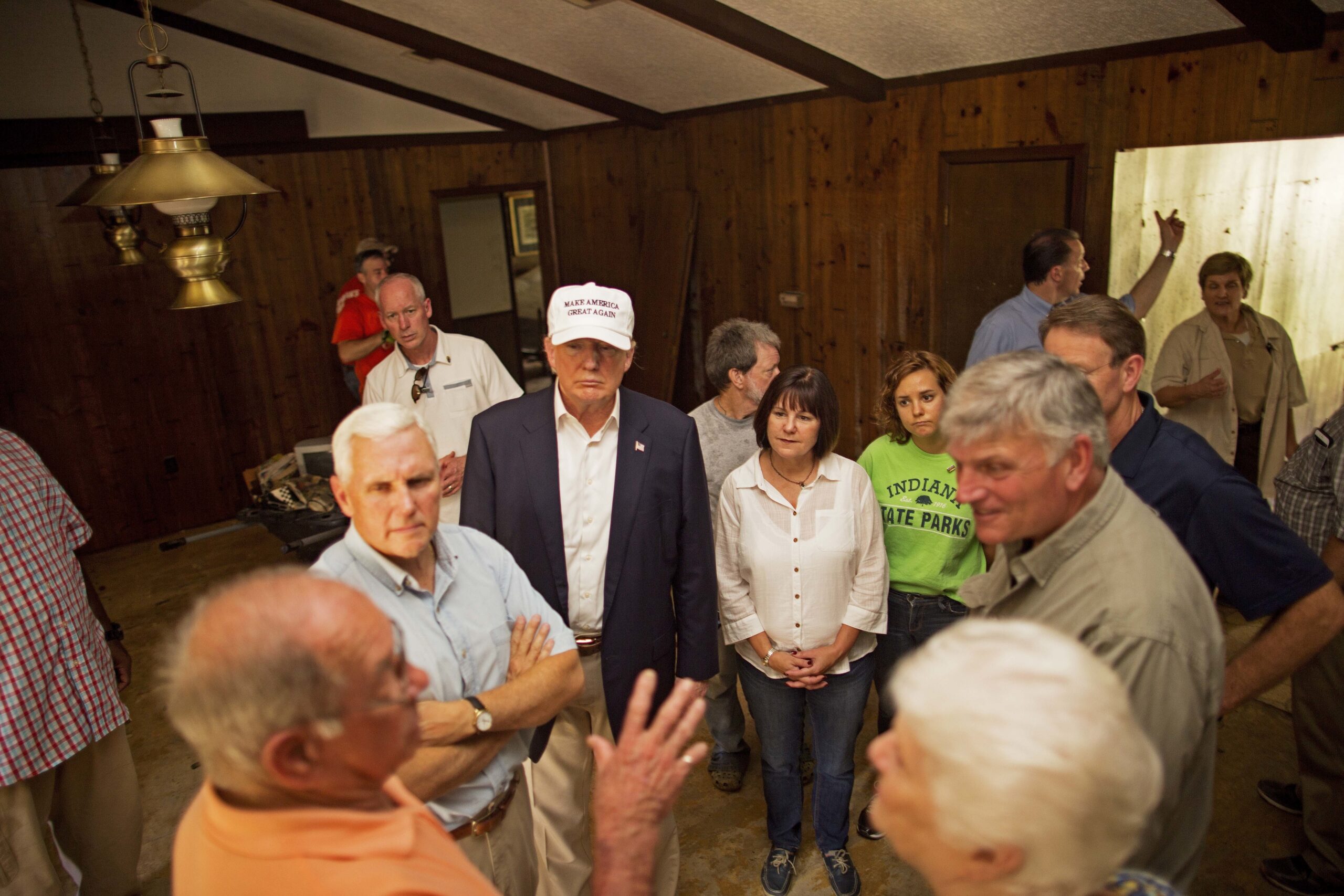 Republican presidential candidate Donald Trump, center, and his running mate, Indiana Gov. Mike Pence, listens to flood victims Jimmy and Olive Gordan during a tour of their flood damaged home in Denham Springs, La., (AP)