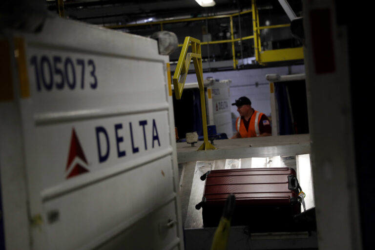In this July 12, 2016, photo, a suitcase rides a carousel after being unloaded from a Delta Air Lines flight at Baltimore-Washington International Thurgood Marshall Airport in Linthicum, Md. Delta Air Lines is rolling out new technology to better track bags throughout its system. (AP Photo/Patrick Semansky) (AP)