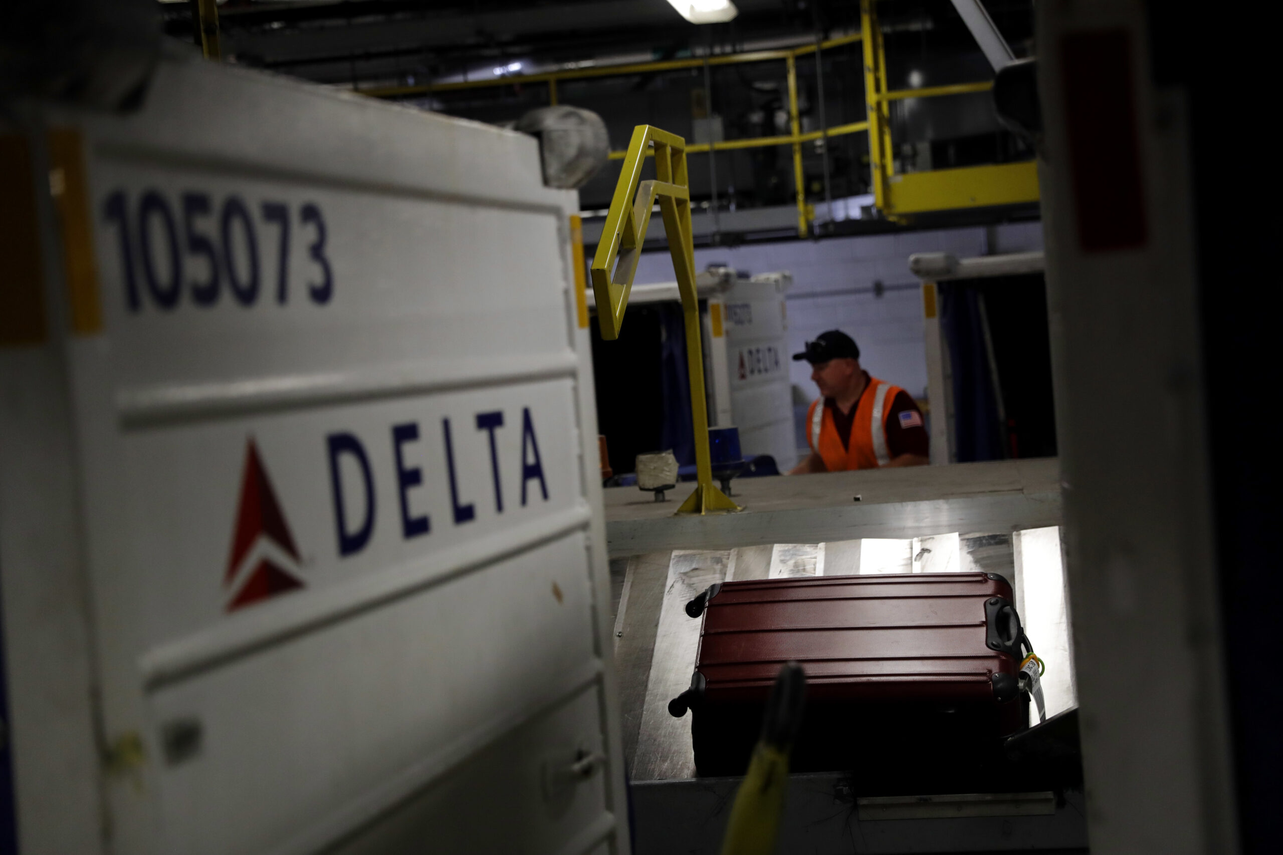 In this July 12, 2016, photo, a suitcase rides a carousel after being unloaded from a Delta Air Lines flight at Baltimore-Washington International Thurgood Marshall Airport in Linthicum, Md. Delta Air Lines is rolling out new technology to better track bags throughout its system. (AP Photo/Patrick Semansky) (AP)