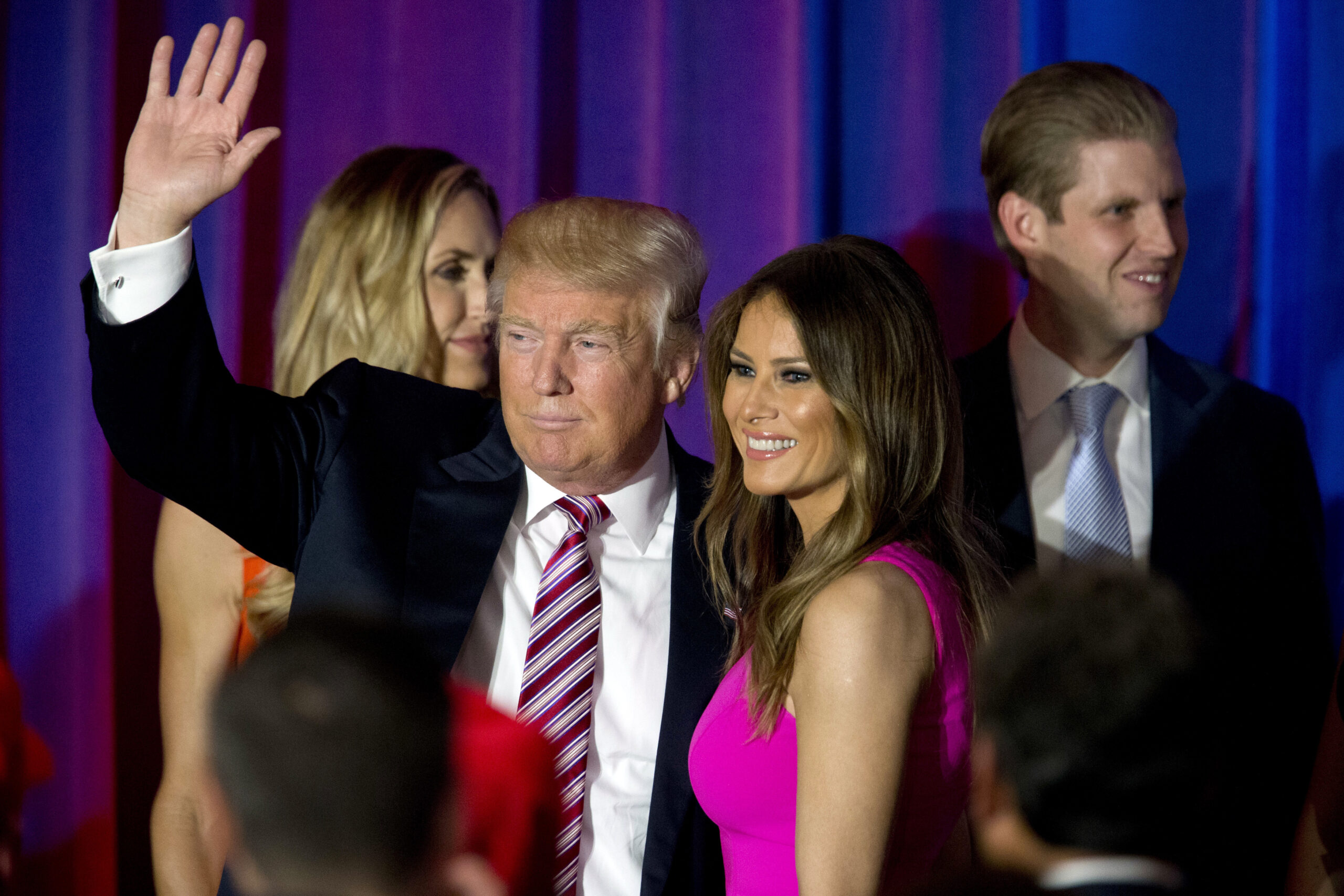 FILE - In this June 7, 2016 file photo, Republican presidential candidate Donald Trump waves at supporters as he leaves the stage with his wife Melania after a news conference at the Trump National Golf Club Westchester in Briarcliff Manor, N.Y.  Melania Trump's former modeling agent says the wife of the GOP presidential nominee obtained a work visa before she modelled professionally in the U.S. in the mid-1990s. ( Photo/Mary Altaffer, File) (AP Photo/Mary Altaffer, File)
