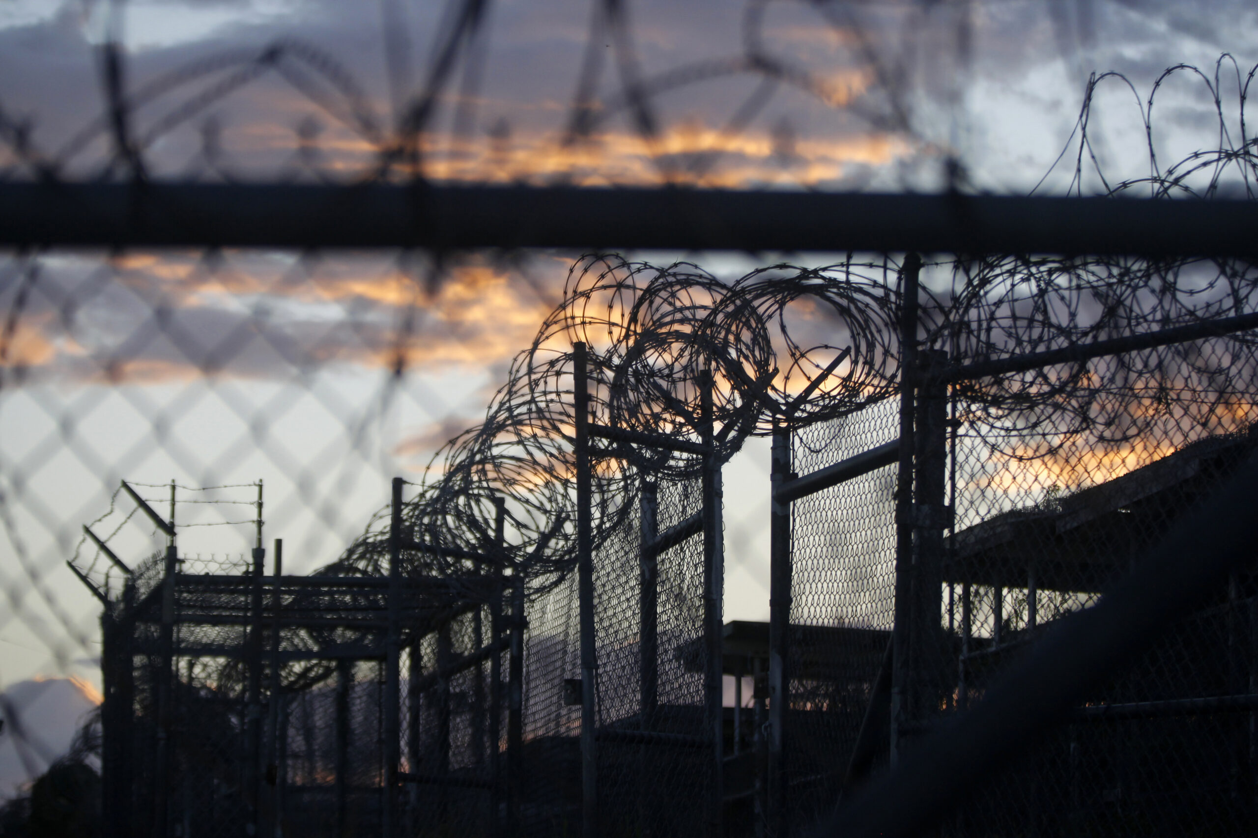 FILE - In this Nov. 21, 2013 file photo reviewed by the U.S. military, dawn arrives at the now closed Camp X-Ray, which was used as the first detention facility for al-Qaida and Taliban militants who were captured after the Sept. 11 attacks, at the Guantanamo Bay Naval Base, Cuba. The Pentagon announced Monday, Aug. 15, 2016, that fifteen prisoners at the Guantanamo Bay detention center were released to the United Arab Emirates in the single largest transfer of detainees during the Obama administration. (AP Photo/Charles Dharapak, File) (AP)