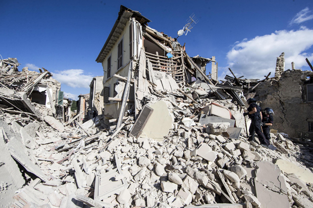 Rescuers search for survivors under the rubble of the town of Amatrice, central Italy following an earthquake, August 24, 2016. (AP/Massimo Percossi)