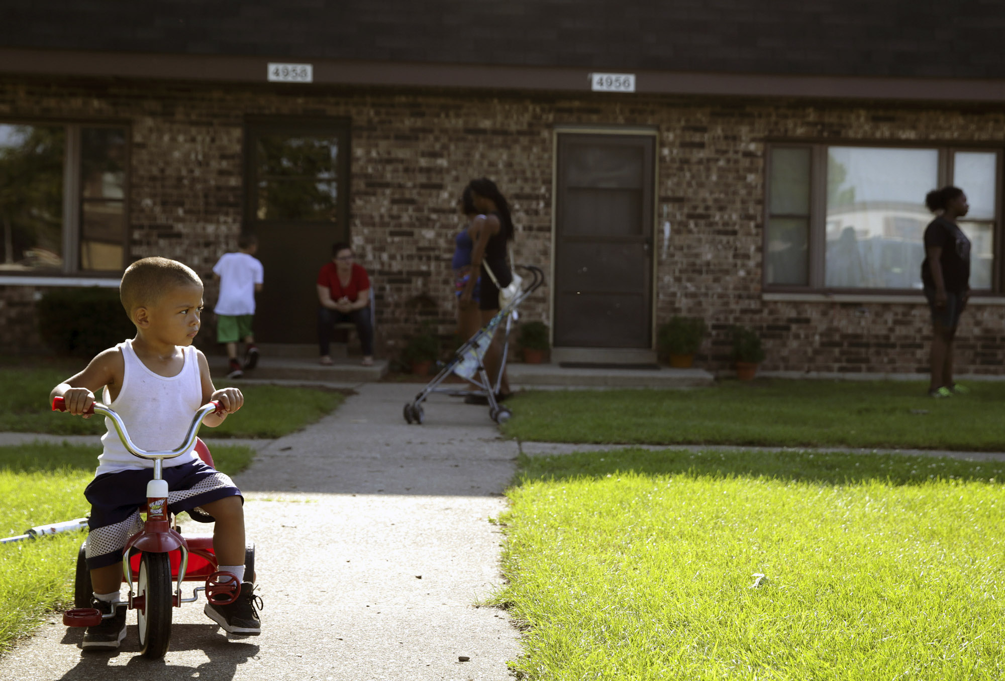 In this Aug. 3, 2016 photo, Joseph Russell, 2, rides his tricycle outside his home at the West Calumet Housing Complex in East Chicago, Ind. More than 1,000 residents of a public housing complex in northwest Indiana have been left in a state of panic and uncertainty since authorities informed them last month that their homes need to be destroyed because of a serious lead contamination threat. (Jonathan Miano/The Times via AP) (AP)