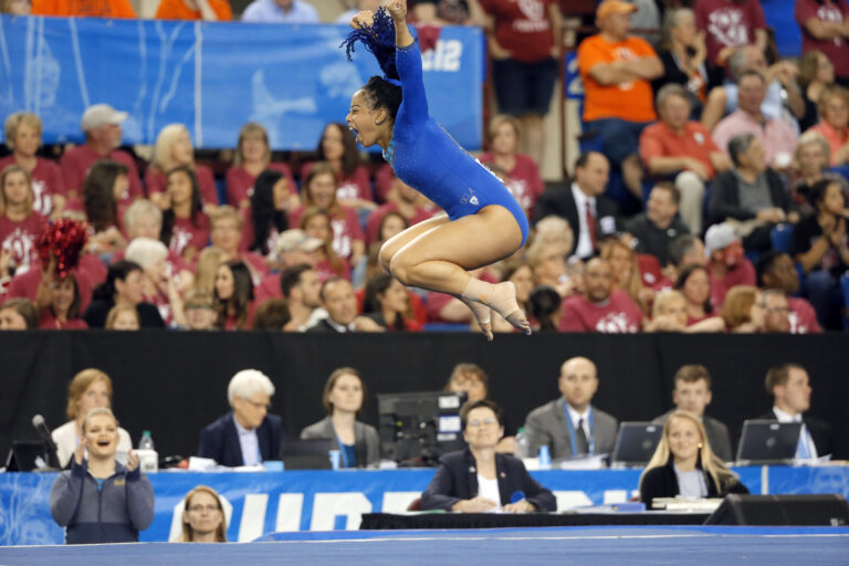 FILE - In this April 16, 2016, file photo, UCLA's Sophina DeJesus celebrates after her floor exercise routine during the NCAA women's gymnastics championships in Fort Worth, Texas. (AP Photo/Tony Gutierrez, File) (AP)