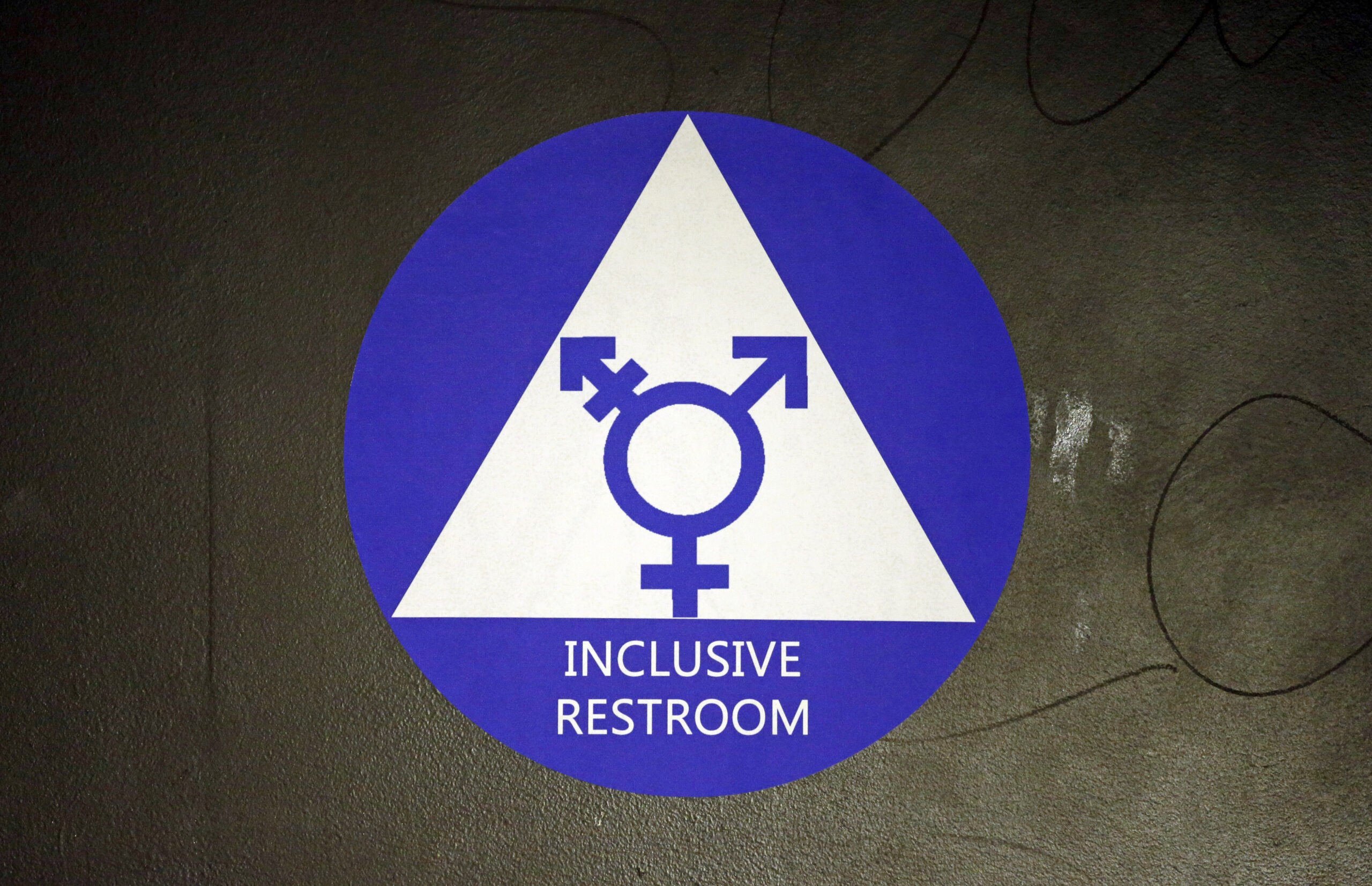 FILE - In this May 17, 2016, file photo, a new sticker designates a gender neutral bathroom at Nathan Hale high school in Seattle. A federal judge in Texas is blocking for now the Obama administration's directive to U.S. public schools that transgender students must be allowed to use the bathrooms and locker rooms consistent with their chosen gender identity. () (AP Photo/Elaine Thompson, File)