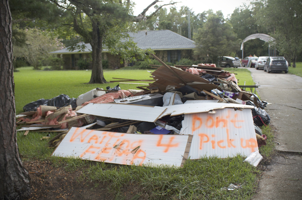 Debris piled up from flooded home on Hodgeson Road in Prairieville, Louisiana  on Sunday (Lisa O'Neill)