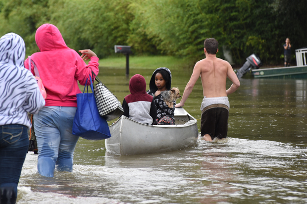 A young girl silently looks back at her family after being rescued from floodwaters that overtook Comite Drive and the surrounding neighborhoods in Central on Saturday. (The Advocate/Caroline Ourso)