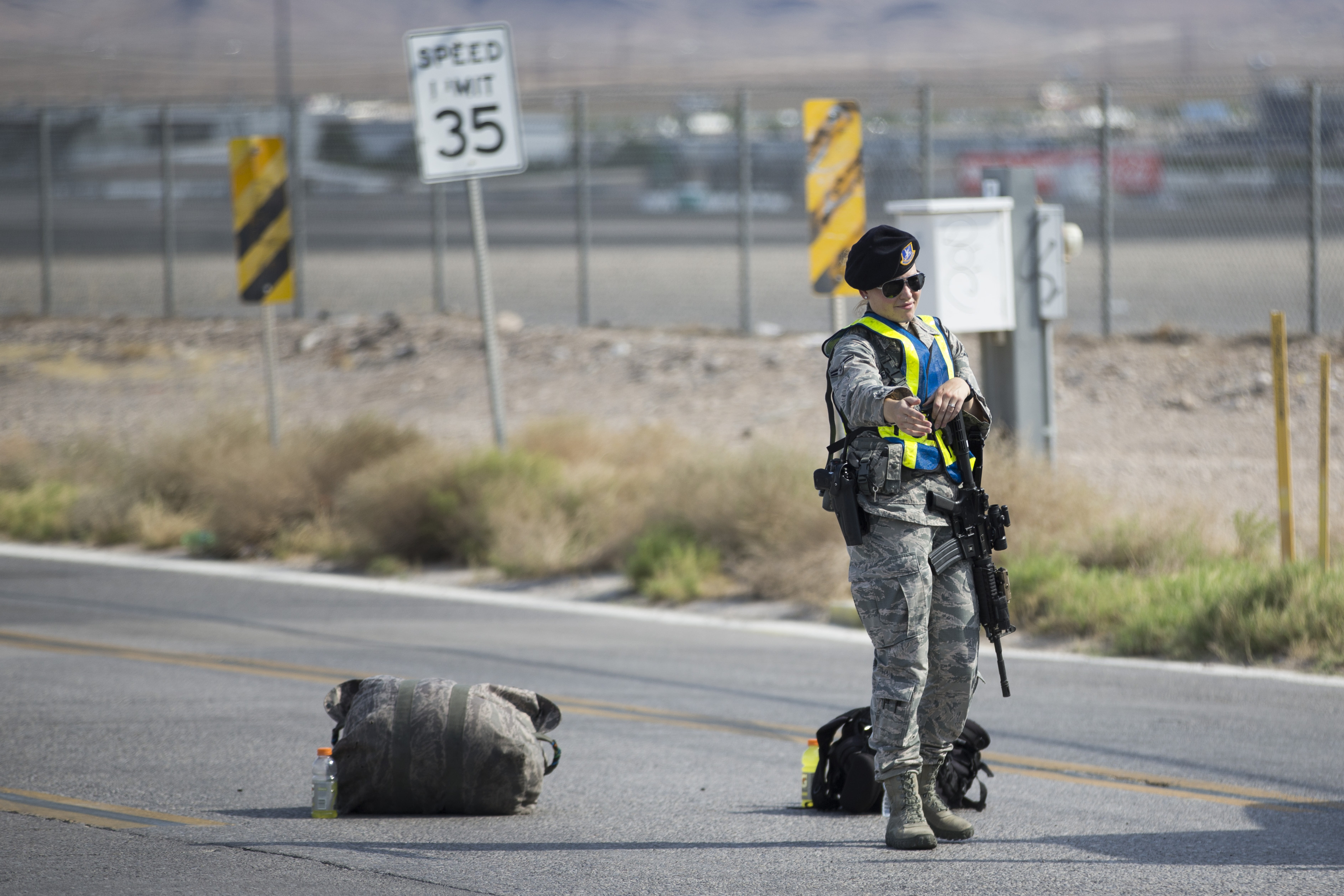Nellis Air Force Base military police block the road at the intersection of North Las Vegas Boulevard and North Hollywood Boulevard after an aircraft crash near the area on Thursday, Aug. 18, 2016, in Las Vegas. An official says a veteran pilot had just completed an exercise with a military weapons school at an Air Force base near Las Vegas when he ejected as the plane went down. (Erik Verduzco/Las Vegas Review-Journal via AP) (AP)