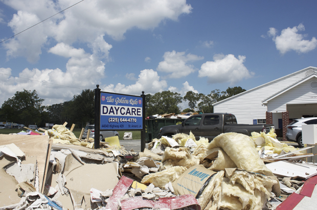 Piles of debris sit outside the Golden Rule Daycare in St. Amant, Louisiana. 140 children attend the daycare, which owners estimate won't reopen for four months. (Lisa M. O'Neill)