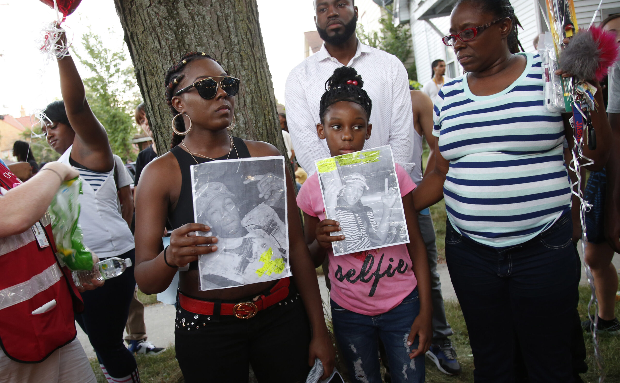 Family members of Sylville Smith gather where he was shot and killed by Milwaukee police in Milwaukee, Sunday, Aug. 14, 2016. Police in Milwaukee say a black man whose killing by police touched off arson and rock-throwing was shot by a black officer after turning toward him with a gun in his hand. Wisconsin's governor, meanwhile, has put the National Guard on standby in case of more violence Sunday night. (AP Photo/Jeffrey Phelps) (AP)