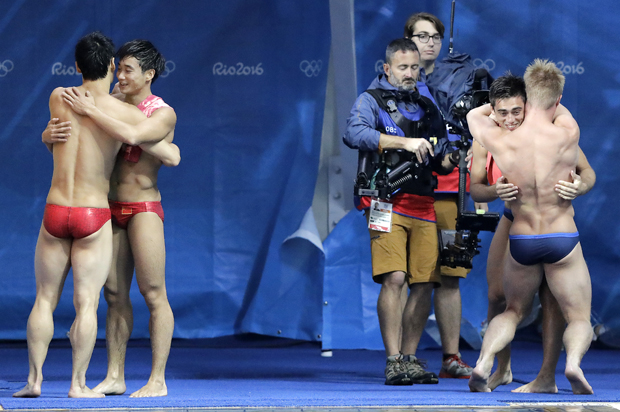 China's Cao Yuan and Qin Kai; Britain's Jack Laugher and Chris Mears hug after the men's synchronized 3-meter springboard diving final at the 2016 Summer Olympics, Aug. 10, 2016. (AP/Wong Maye-E)