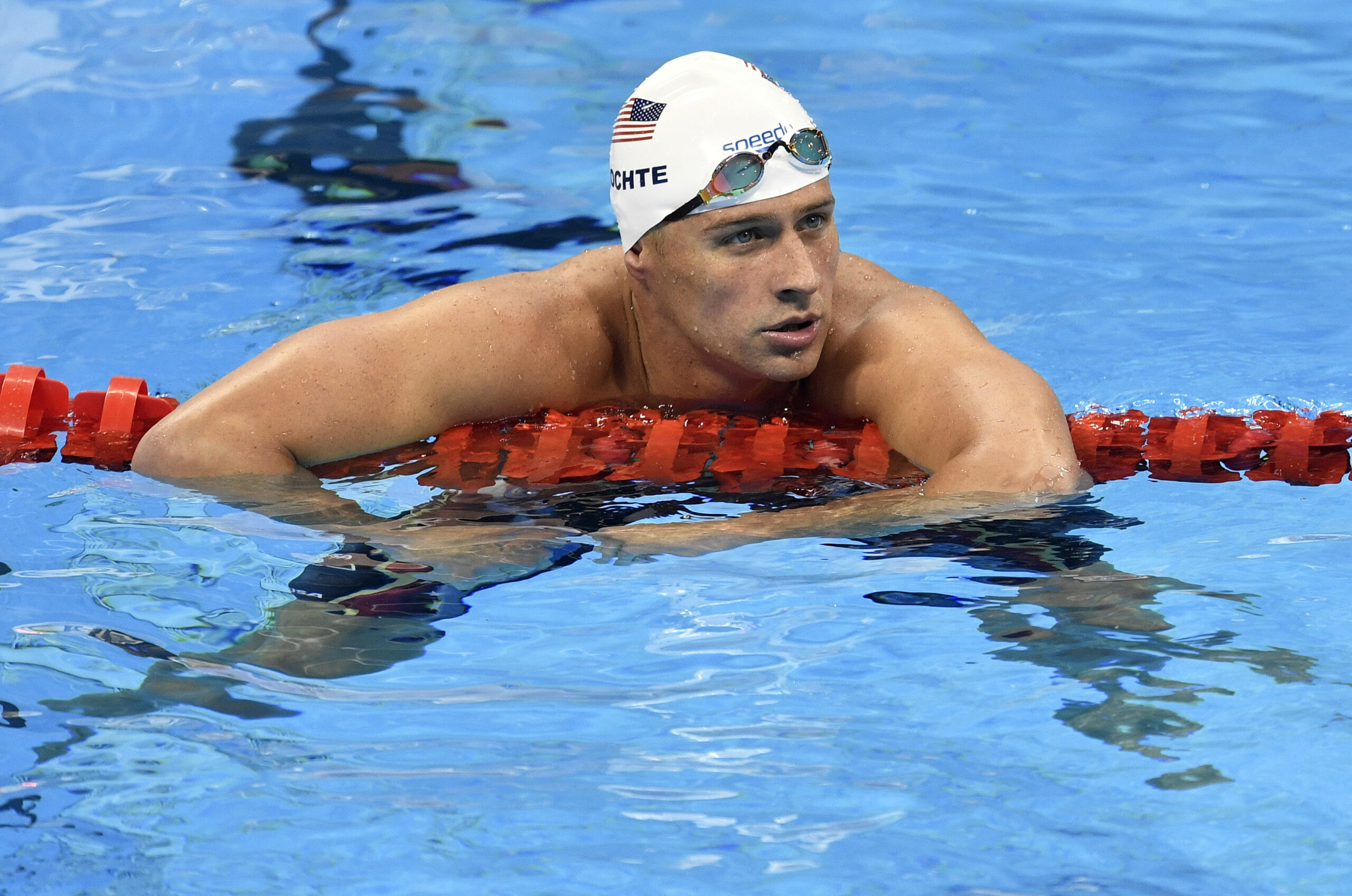 FILE - In this Aug. 9, 2016, file photo, United States' Ryan Lochte checks his time after a men' 4x200-meter freestyle relay heat during the swimming competitions at the 2016 Summer Olympics in Rio de Janeiro, Brazil. The father of the American swimmer said Wednesday, Aug. 17, his son arrived back in the United States before a Brazilian judge ordered that Lochte stay in Brazil as authorities investigate a robbery claim involving the athlete during the Olympics. (AP Photo/Martin Meissner, File) (AP)