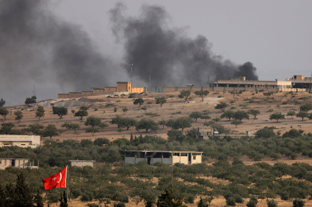 Smoke rises from the Syrian border town of Jarablus as it is pictured from the Turkish town of Karkamis, Turkey, August 24, 2016. (Reuters/Umit Bektas)